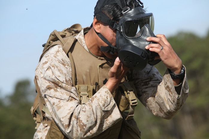 A Marine with Landing Support Company, Combat Logistics Regiment 27, 2nd Marine Logistics Group decontaminates himself using a M291 skin decontamination kit during a readiness exercise aboard Camp Lejeune, N.C., March 28, 2012. The Marines with LS Co. also learned how to properly wear and how to function for an extended period of time in Mission-Oriented Protective Posture gear.