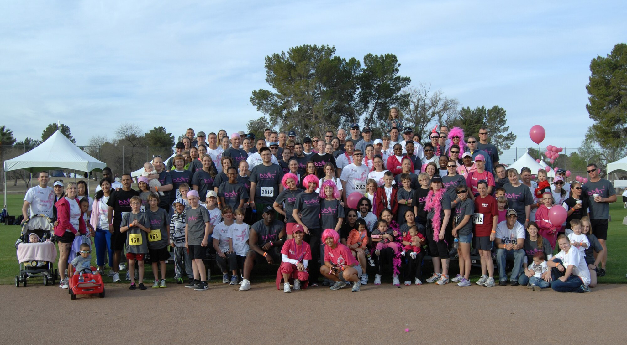 Airmen from Davis-Monthan Air Force Base, Ariz. and their families, pose for a group photo before participating in the Susan G. Komen Race for the Cure 5K at Reid Park March 25. One of the Airmen, Senior Master Sgt. Aubry Herrera, 355th Fighter Wing staff superintendent, has breast cancer and has been fighting it for four years. (U.S. Air Force photo by Airman 1st Class Michael Washburn/Released)