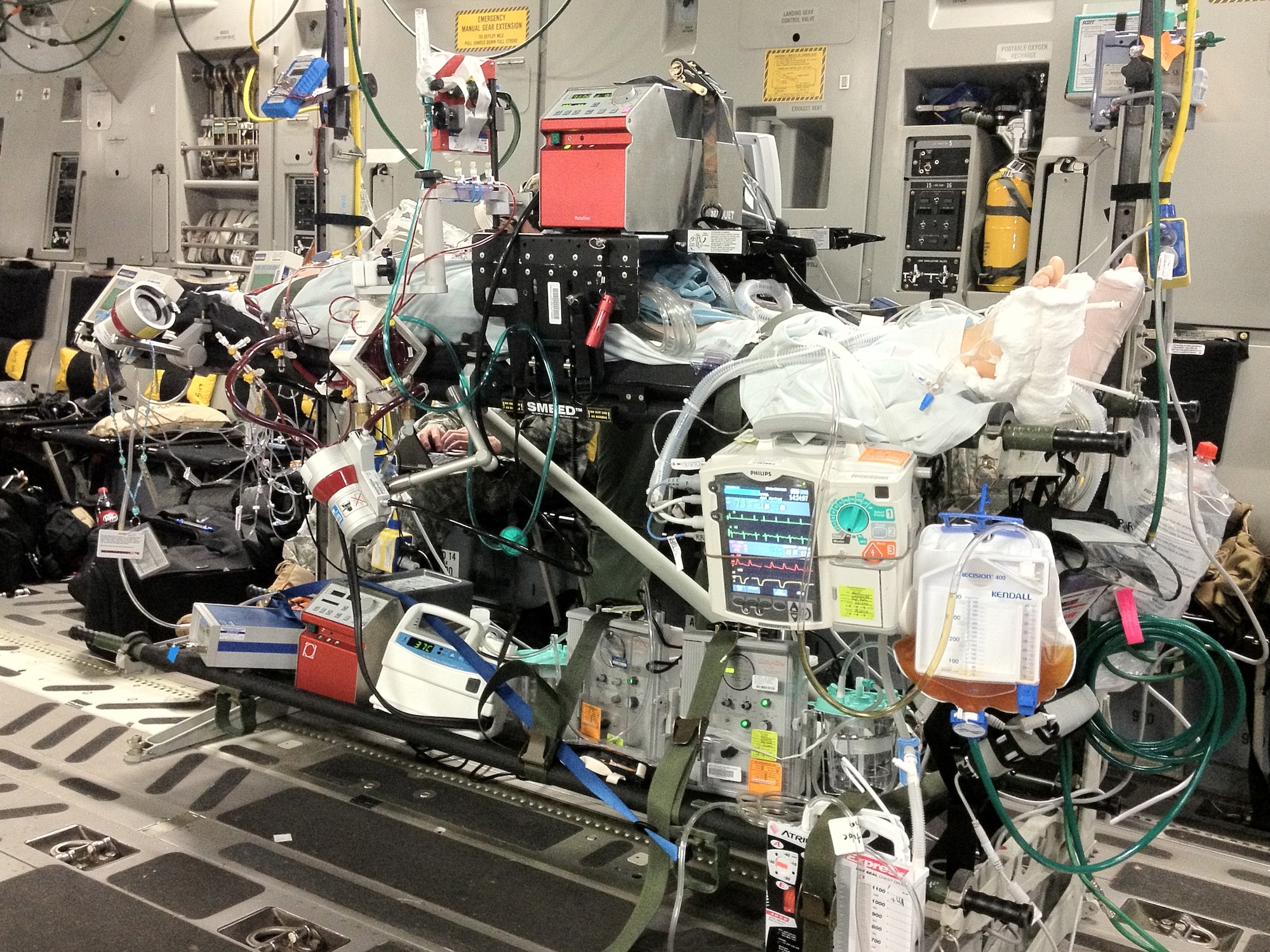 A team of Air Force, Army and civilian specialists (from Kapiolani
Medical Center), and an Air Force Critical Care Air Transport Team bring a
critical care patient from Okinawa to Joint Base Pearl Harbor-Hickam, Hawaii
to be transported to Tripler Army Medical Center.  (U.S. Air Force photo/released)
