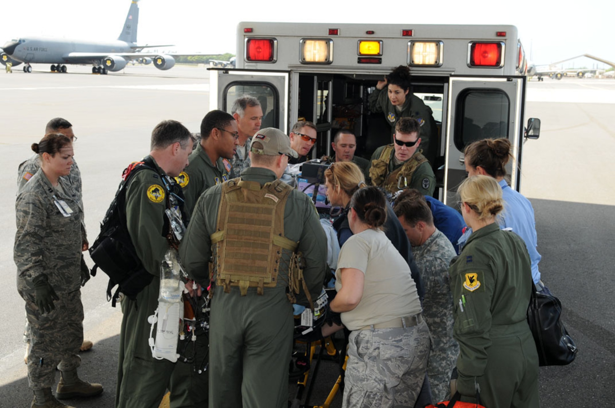 A team of Air Force, Army and civilian specialists (from Kapiolani
Medical Center), and an Air Force Critical Care Air Transport Team bring a
critical care patient from Okinawa to Joint Base Pearl Harbor-Hickam, Hawaii
to be transported to Tripler Army Medical Center.  (Photo by David D.
Underwood, Jr./released)

