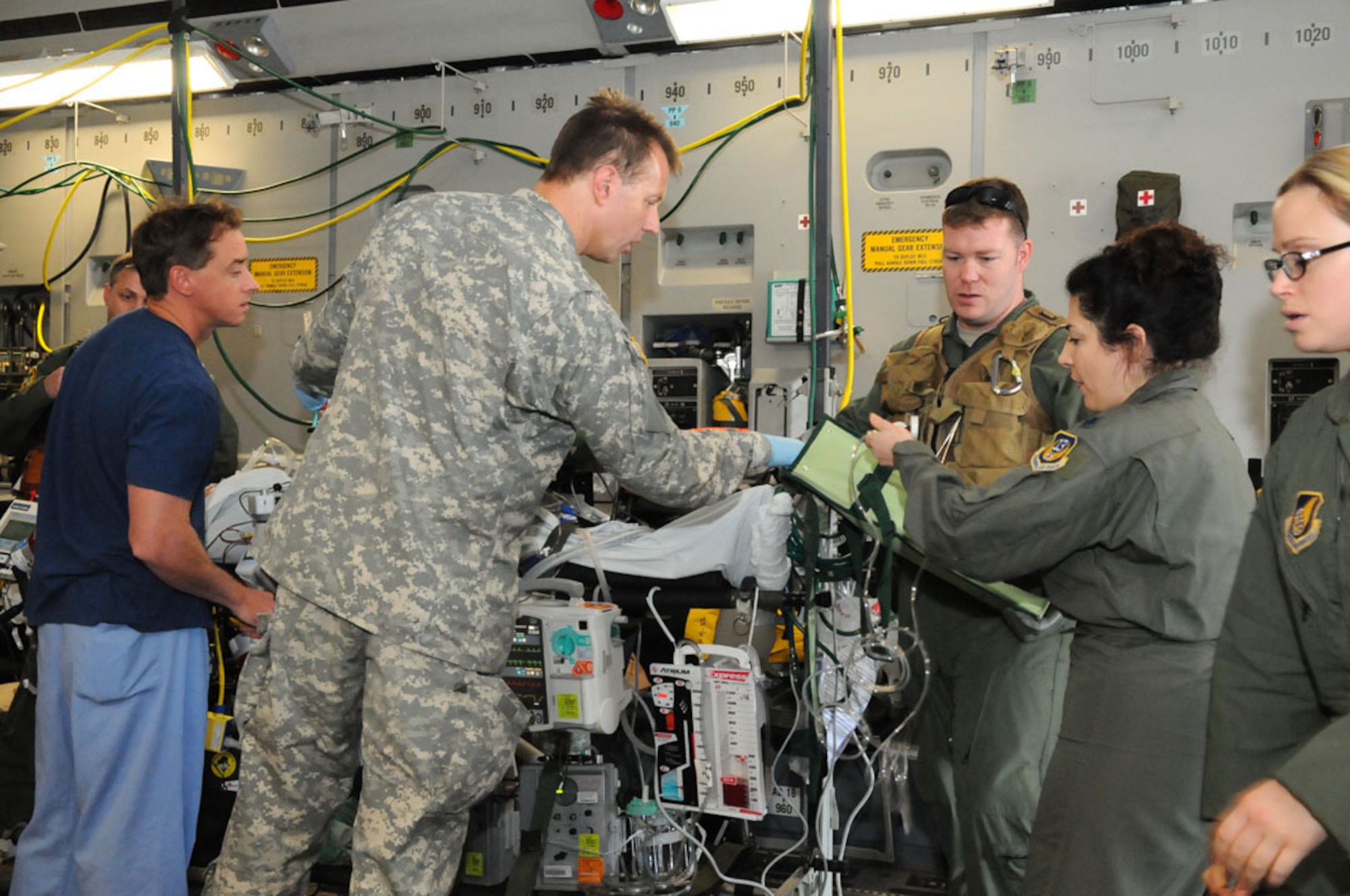 A team of Air Force, Army and civilian specialists (from Kapiolani
Medical Center), and an Air Force Critical Care Air Transport Team bring a
critical care patient from Okinawa to Joint Base Pearl Harbor-Hickam, Hawaii
to be transported to Tripler Army Medical Center.  (Photo by David D.
Underwood, Jr./released)
