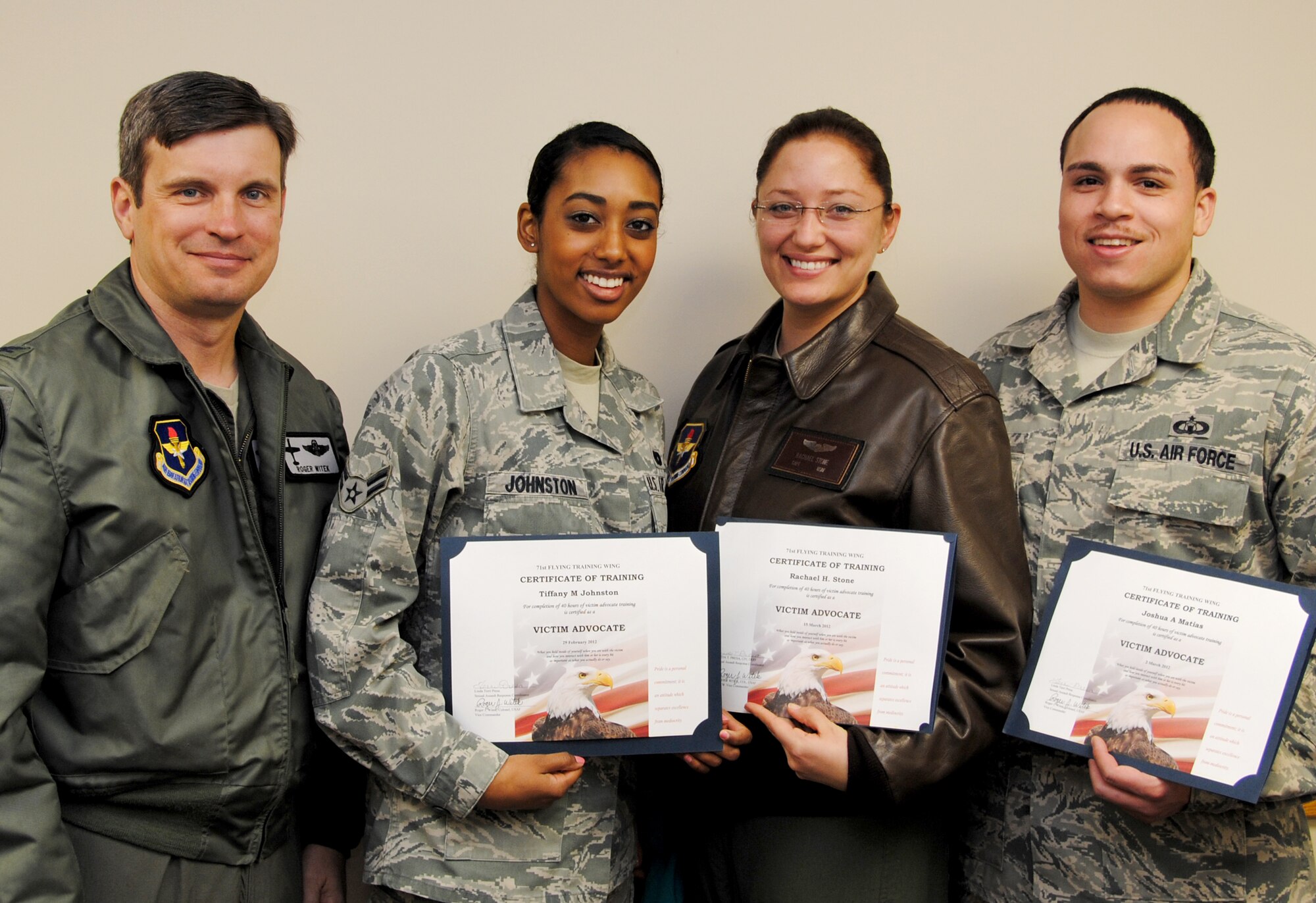 Col. Roger Witek, left, the 71st Flying Training Wing vice commander, presented certificates to the three newest Victims Advocates at Vance Air Force Base, Okla., March 22. From left are Airman 1st Class Tiffany Johnston with the 71st Logistics Readiness Squadron; Capt. Rachael Stone with the 32nd Flying Training Squadron; and Staff Sgt. Joshua Matias with the 71st Operations Support Squadron. All three spent 40 hours learning how to help victims of sexual assault. (U.S. Air Force photo)  