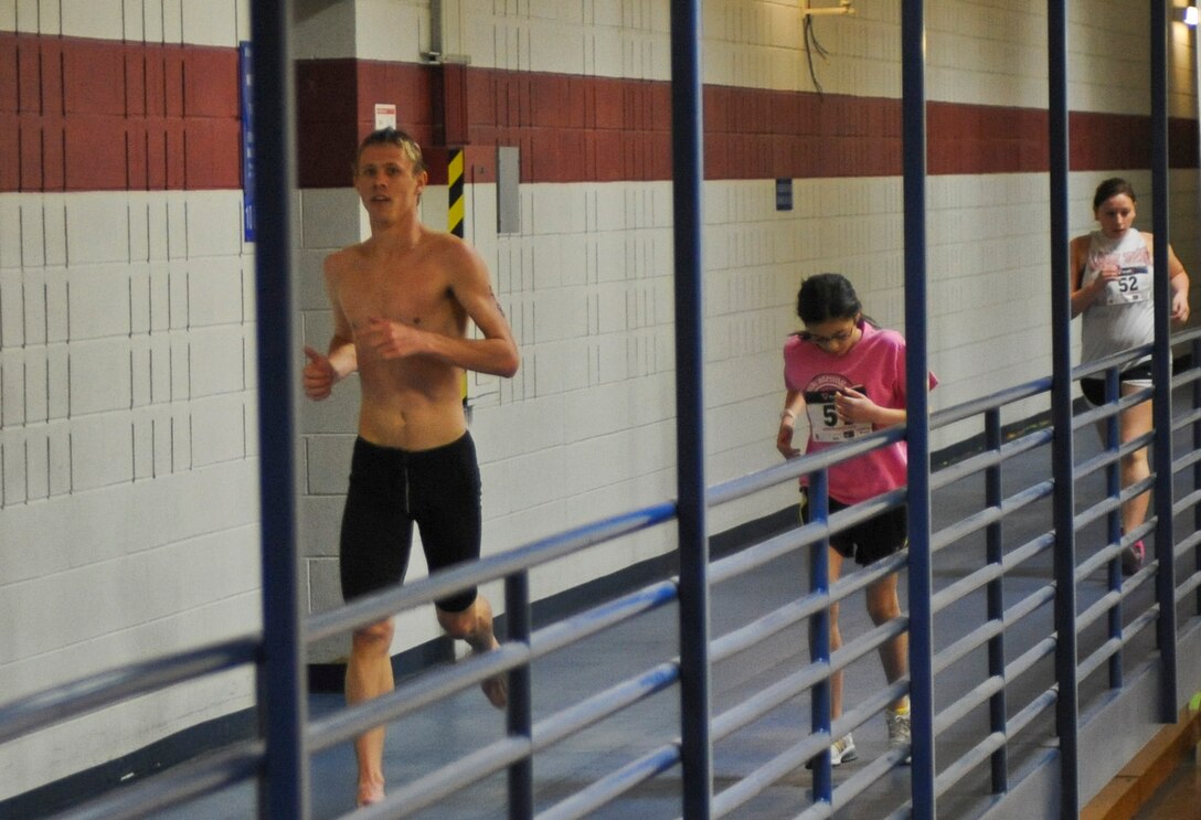Triathlon competitors race on the indoor track during the Bellamy Fitness Center’s Indoor Triathlon at Ellsworth Air Force Base, S.D., March 24, 2012. The competitors ended the triathlon running on the indoor track.  (U.S. Air Force photo by Airman 1st Class Anania Tekurio/Released)