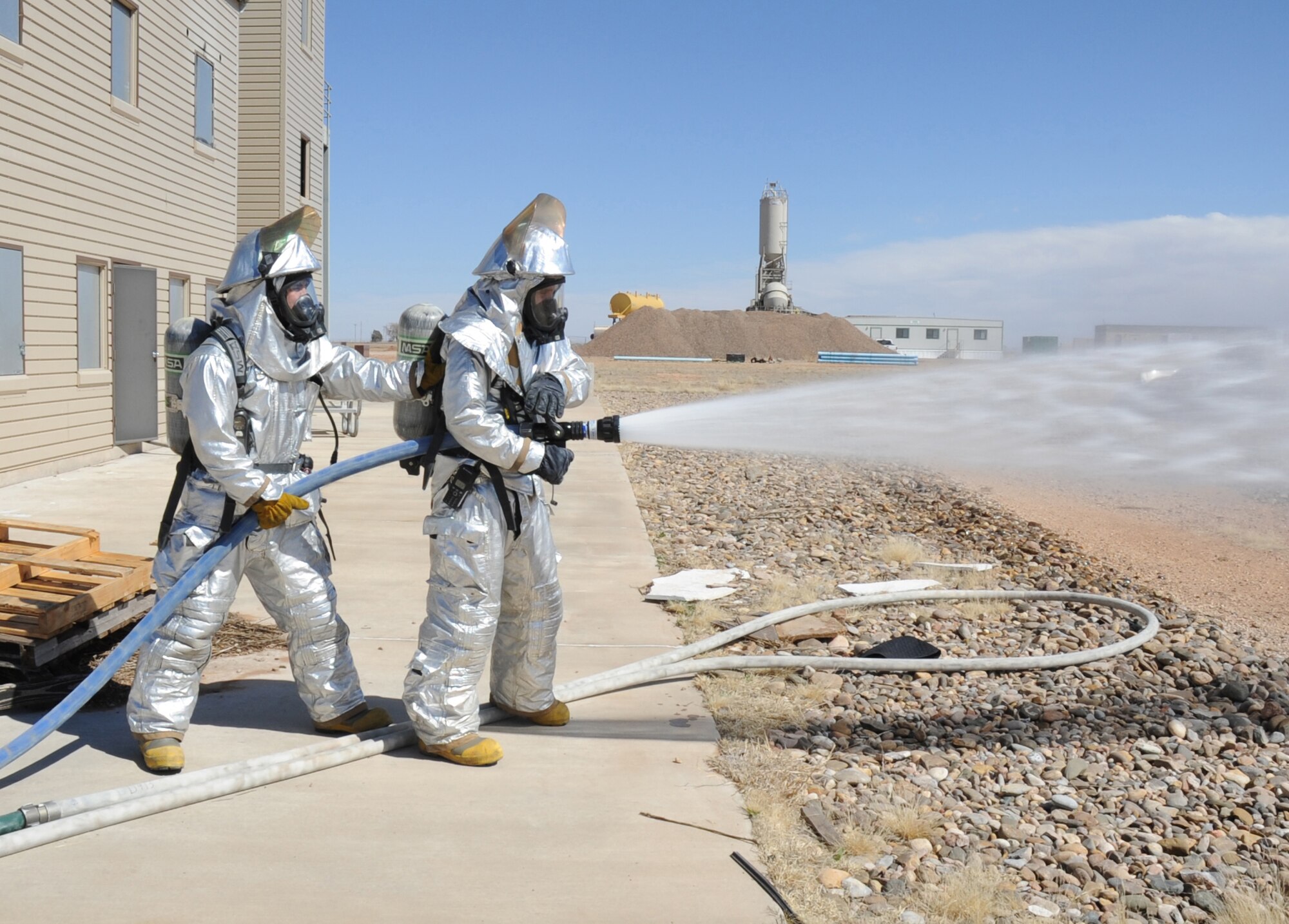 U.S. Air Force firefighters with the 27th Special Operations Civil Engineer Squadron check water functionality and pressure during a controlled burn at Cannon Air Force Base, N.M., March 15, 2012. Firefighting crews routinely perform exercises like this controlled burn to ensure readiness during an actual disaster. (U.S. Air Force photo by Airman 1st Class Alexxis Pons Abascal)