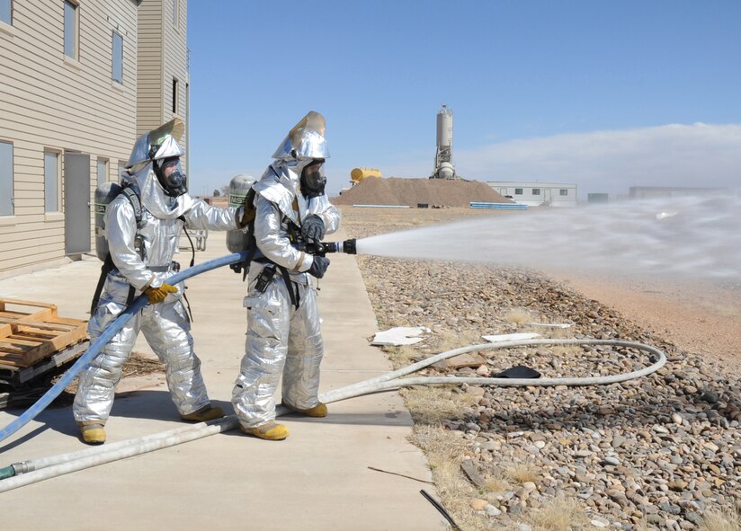 U.S. Air Force firefighters with the 27th Special Operations Civil Engineer Squadron check water functionality and pressure during a controlled burn at Cannon Air Force Base, N.M., March 15, 2012. Firefighting crews routinely perform exercises like this controlled burn to ensure readiness during an actual disaster. (U.S. Air Force photo by Airman 1st Class Alexxis Pons Abascal)