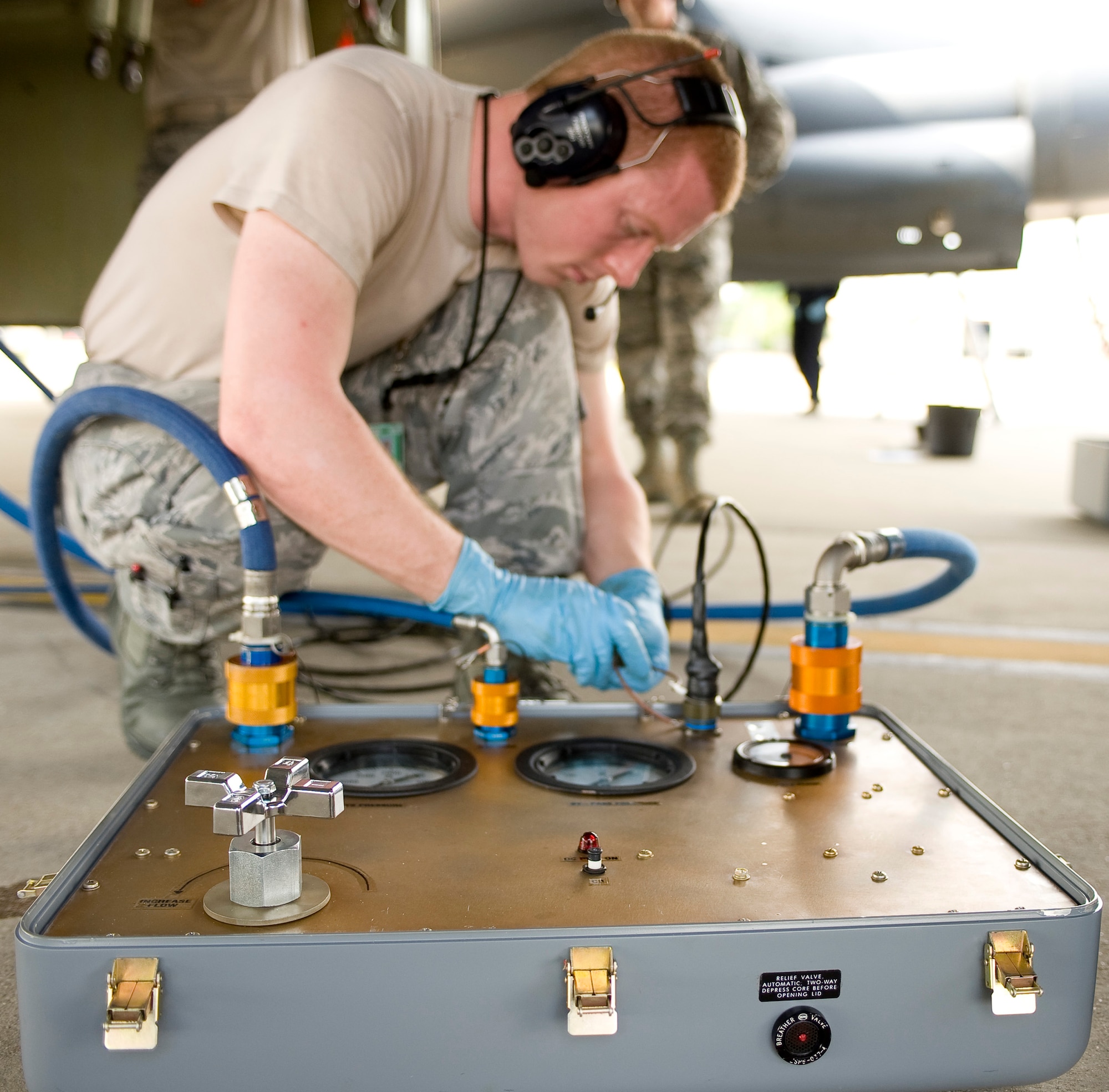 Staff Sgt. Jason Gibson, 20th Aircraft Maintenance Unit hydraulics craftsman, connects an AGM-69 test box to a B-52H Stratofortress on Barksdale Air Force Base, La., March 28. The test box is a prototype used to check the hydraulic flow and pressure that rotates the nuclear weapon rack inside the bomb bay of the aircraft. (U.S. Air Force photo/Senior Airman Chad Warren)(RELEASED)