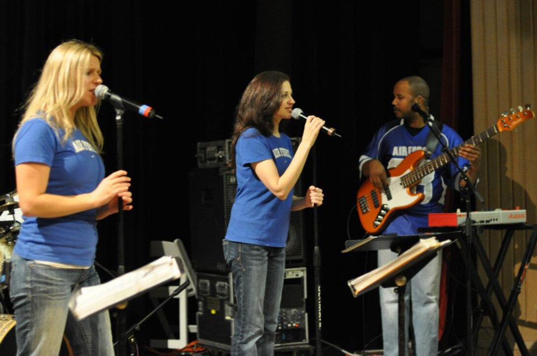 Vocalist SSgt Courtney Clifford, vocalist TSgt Christin Foley and bassist SrA Henry Roberson perform with Top Flight at the Fiesta Military-Civilian Reception.