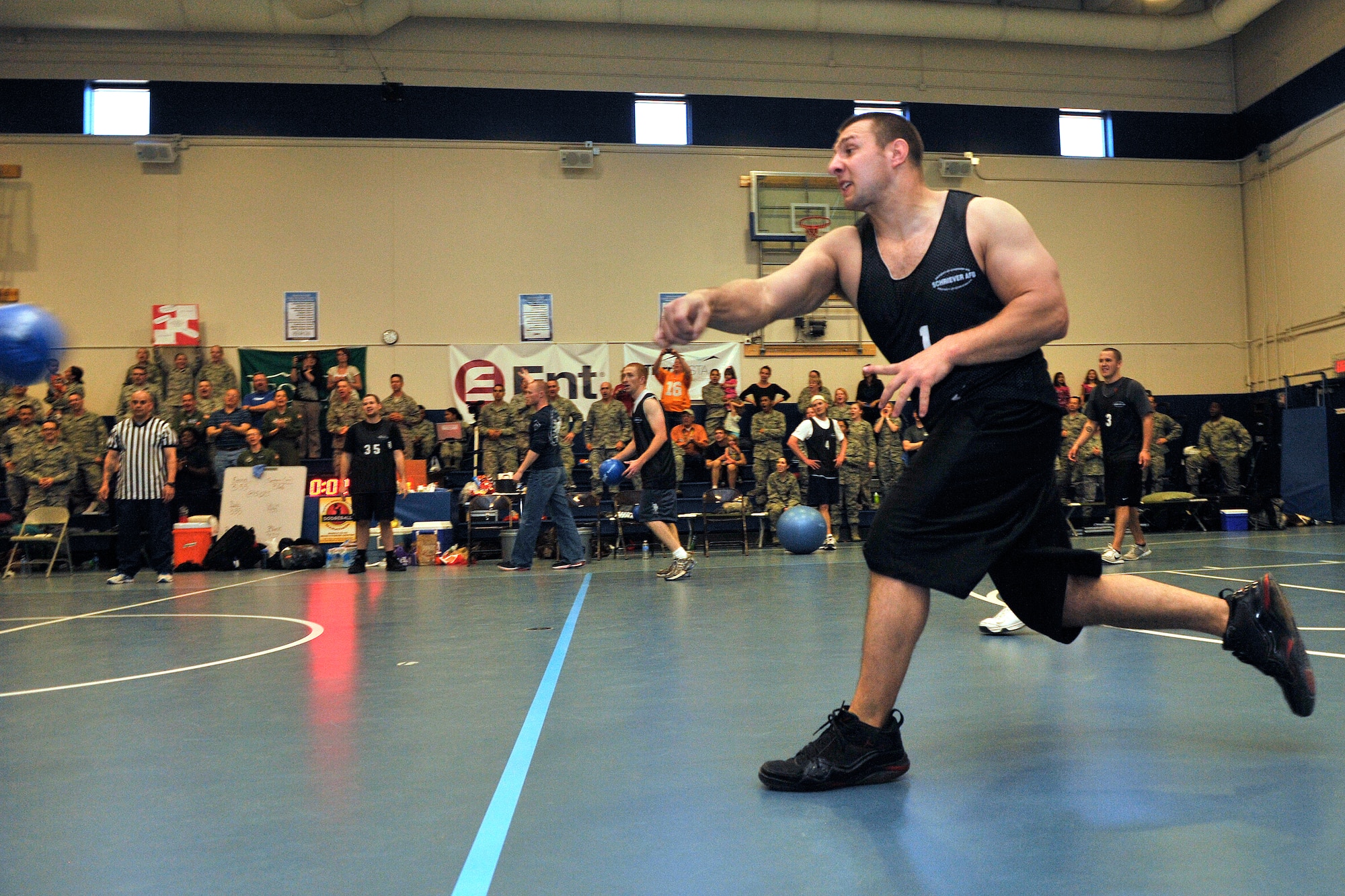 Senior Airman Thomas Hull, 50th Contracting Squadron, lobs a dodgeball at an unsuspecting Red Team member during the 40-hour dodgeball marathon. The marathon raised more than $1000 for the Air Force Assistance Fund. (U.S. Air Force photo/Bill Evans)