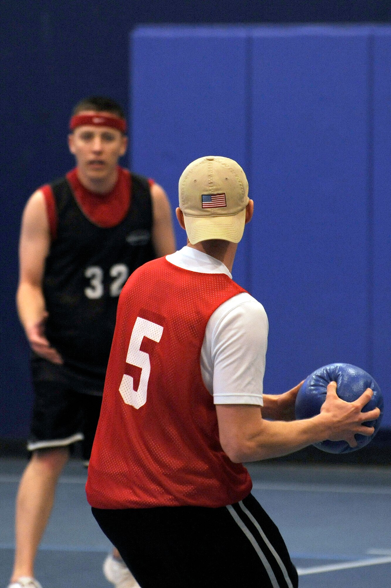 Senior Airman Samual Weaver, 50th Space Communications Squadron, gets ready to launch a dodgeball at 1st. Lt. Doug Bates, 50th Mission Support Group. The two were on opposing teams throughout the 40-hour dodgeball marathon. (U.S. Air Force photo/Bill Evans)