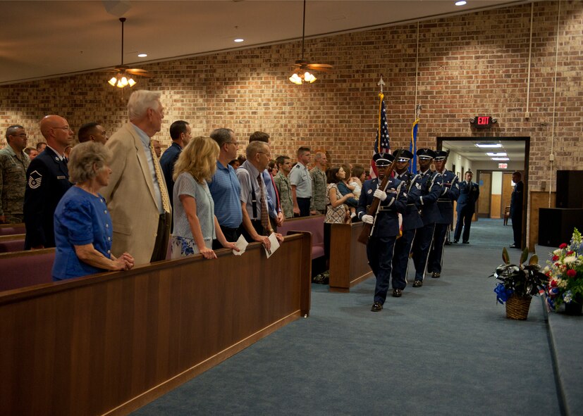 Family members and co-workers gather for a memorial service to honor the life of U.S. Air Force Airman 1st Class Stephen Bost, 23d Logistics Readiness Squadron, at the Base Chapel while the Moody Air Force Base Honor Guard posts the colors for the national anthem at Moody Air Force Base, Ga., March 26, 2012. Bost, who passed away March 17, 2012, enjoyed four wheeling, hunting, fishing and spending time with his family. (U.S. Air Force photo by Senior Airman Eileen Meier/Released)

