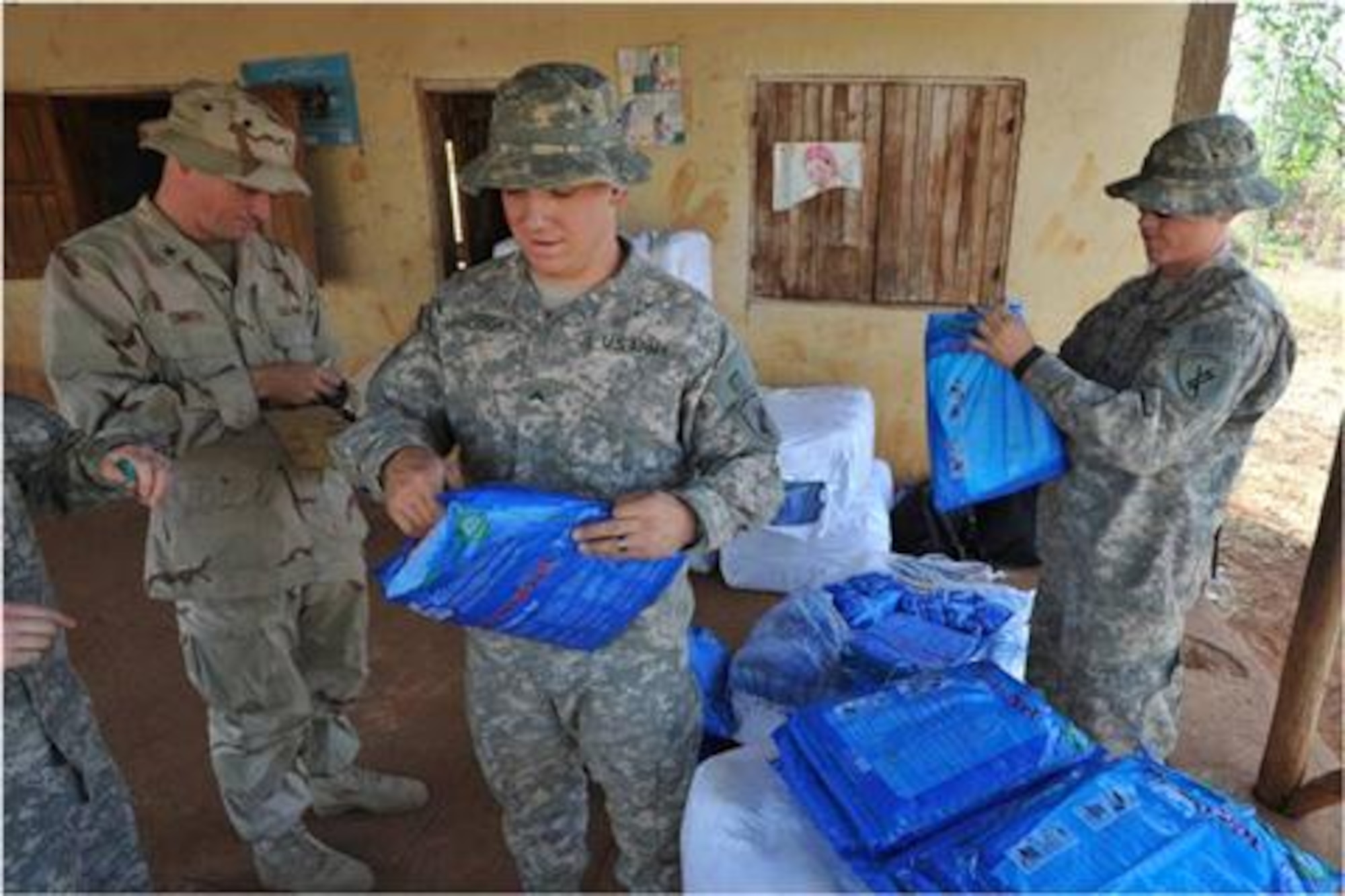 DEBAKA DEBOBESA, Ethiopia (Mar. 15, 2012) - U.S. Army Specialist Cody Clayton takes a ticket for a bed net from an Ethiopian woman from Debaka Debobesa, Ethiopia on 15 March. Clayton and members of Civil Affairs Team 4905 delivered 18,000 packs of insecticide-treated bed nets, rope and nails to Ethiopians in Samaro and Debaka Debobesa, March 15 and 16 as part of an effort to hinder a seasonal spike of malaria in the region. (U.S. Air Force photo by Technical Sergeant James Brock)
