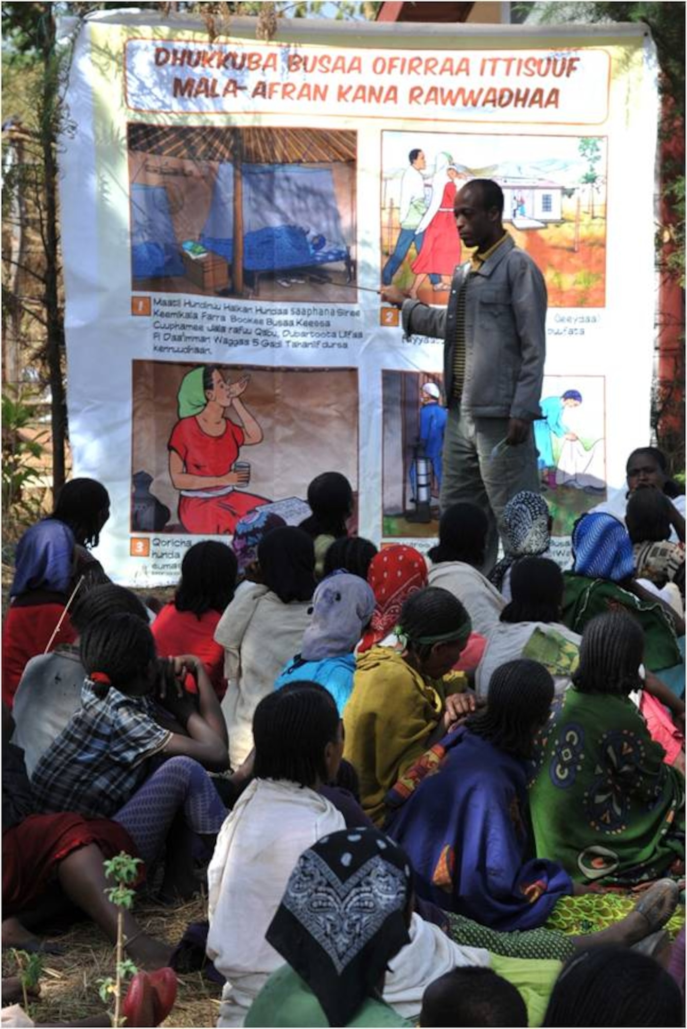 DEBAKA DEBOBESA, Ethiopia (Mar. 15, 2012) - A Health Station worker in Debaka Debobesa Ethiopia instructs a group of Ethiopians on the proper use of a mosquito bed net March 15. Tens of thousands insecticide-treated bed nets were delivered by Civil Affairs Team 4905 to Ethiopians in Samaro and Debaka Debobesa, March 15 and 16 as part of an effort to quell seasonal spike of malaria in the region. (U.S. Air Force photo by Technical Sergeant James Brock)