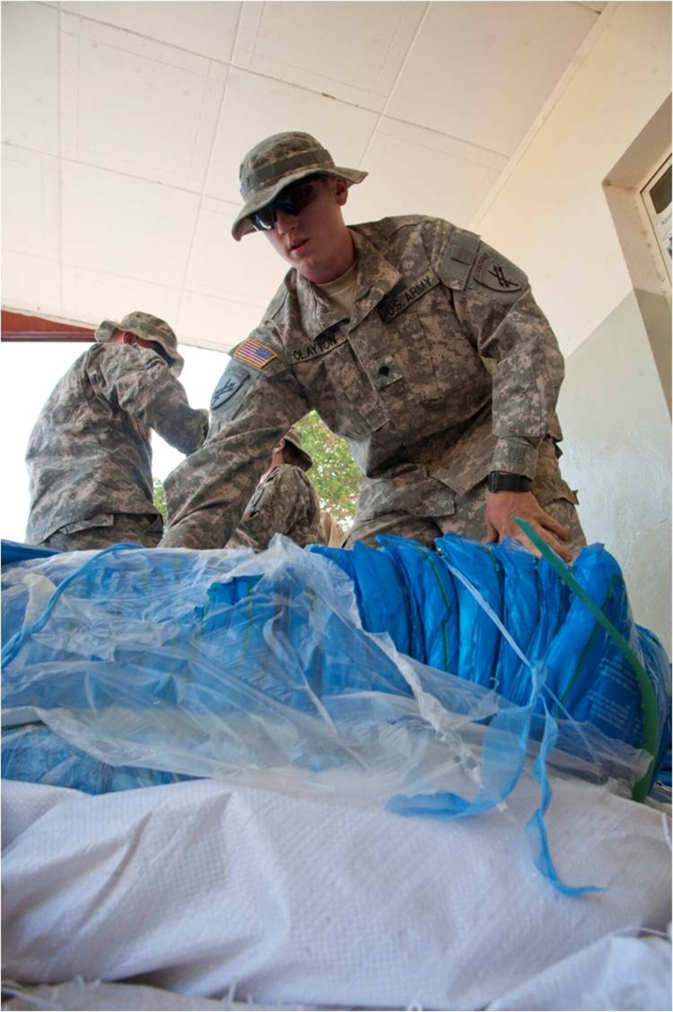 DEBAKA DEBOBESA, Ethiopia (Mar. 15, 2012) - U.S. Army Specialist Cody Clayton, Civil Affairs Team 4905 civil affairs specialist and a Denton, Texas, native prepares insecticide-treated nets for distribution in Debaka Debobesa, Ethiopia, March 15. CAT 4905 delivered 18,000 packs of insecticide-treated bed nets, rope and nails to Ethiopians in Samaro and Debaka Debobesa, March 15 and 16 as part of an effort to curb an expected spike of malaria in the region. (U.S. Air Force photo by Staff Sergeant Andrew Caya)