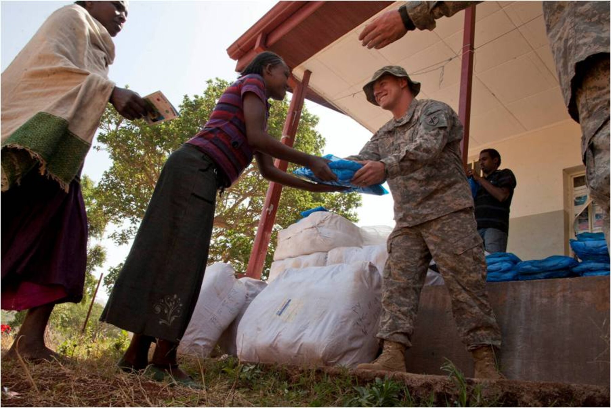 DEBAKA DEBOBESA, Ethiopia (Mar. 15, 2012) - U.S. Army Corporal Benjamin Whiddon, a Houston, Texas, native and Civil Affairs Team 4905 medic, hands a insecticide-treated net to an Ethiopian woman in Debaka Debobesa, Ethiopia, March 15, 2012. As part of an effort to deter a seasonal spike of malaria in the region, CAT 4905 delivered 18,000 packs of insecticide-treated bed nets, rope and nails to Ethiopians in Samaro and Debaka Debobesa, March 15 and 16. (U.S. Air Force photo by Staff Sergeant Andrew Caya)