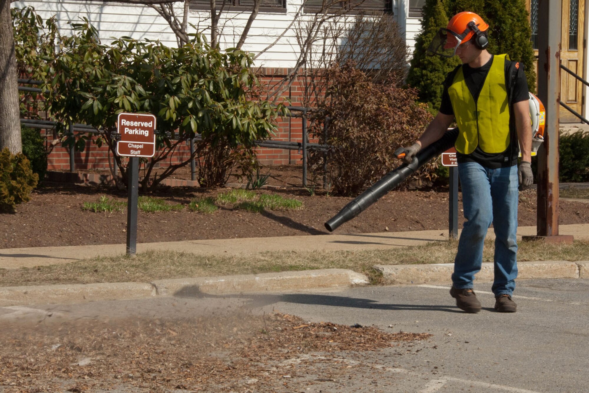 HANSCOM AIR FORCE BASE, Mass. – Nick Banks, Civil Engineering roads and grounds crew member, blows away debris in front of the base chapel March 19. CE crews are hard at work around the base with the arrival of spring. (U.S. Air Force photo by Linda LaBonte Britt)