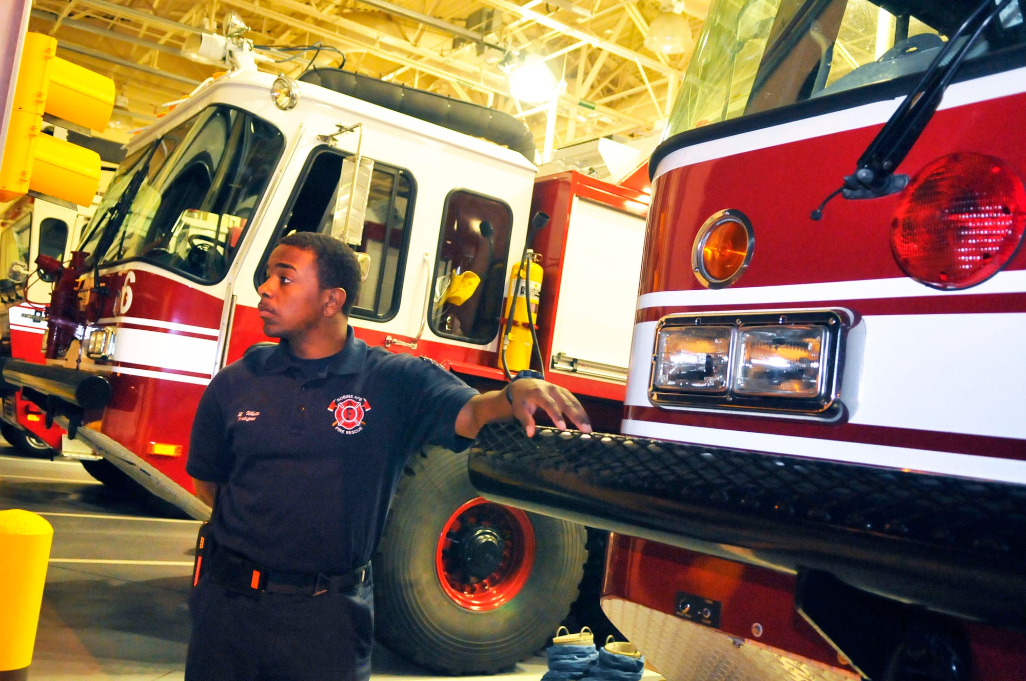 Marcus White, a Robins Fire Department lieutenant, looks over the flightline from the bay area of the fire station during the night shift. (U. S. Air Force photo by Sue Sapp)