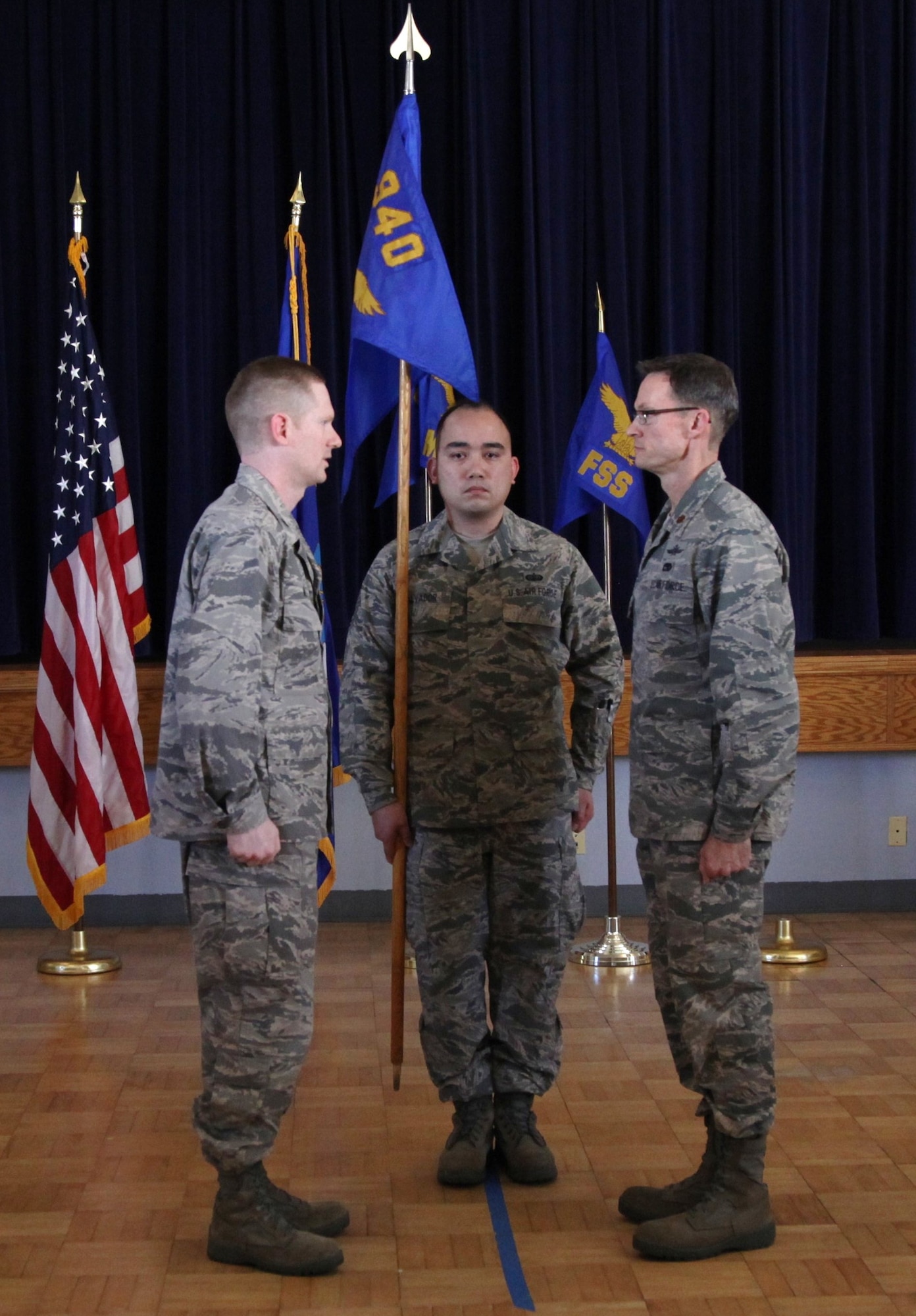 Maj. Andres Lange (right) prepares to assume command of the 940th Communications Flight from 940th Mission Support Group Deputy Commander, Lt. Col. Sean Mitts (left), as Tech. Sgt. David Salvador (center) shoulders his unit's flag. The Assumption of Command ceremony was held at the Community Activity Center on Beale Air Force Base, Calif., during the 940th WIng's Unit Training Assembly, March 4, 2012. (U.S. Air Force photo/Tech. Sgt. Kenneth McCann) 