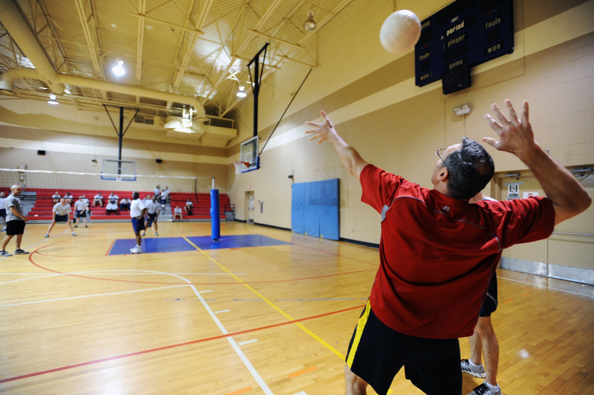 U.S. Air Force Chief Master Sgt. Brian Rogers, Air Force Central A6 chief enlisted manager, serves the ball to Airmen Leadership School Ravens flight during a volleyball game ALS versus Chiefs at the Fitness Center, Shaw Air Force Base, S.C., March 20, 2012. ALS is a five-week course designed to turn Airmen into supervisors that focuses on leadership and leadership duties. (U.S. Air Force photo by Senior Airman Tabatha McCarthy/released)