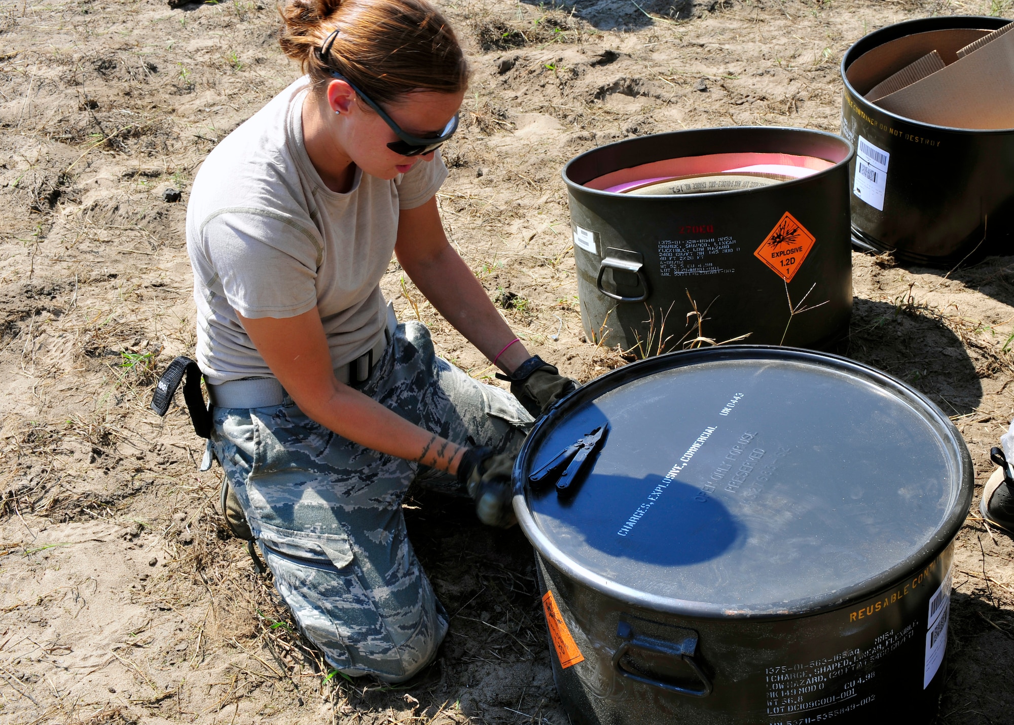 Senior Airman Kristi Stubbs, 20th Civil Engineer Squadron explosive ordnance disposal technician, opens up a container for explosives at Poinsett Range near Wedgefield, S.C., Sept. 23, 2010. EOD techs are called upon when unexploded bombs need to be dealt with. (U.S. Air Force photo by Senior Airman Daniel Phelps/Released)