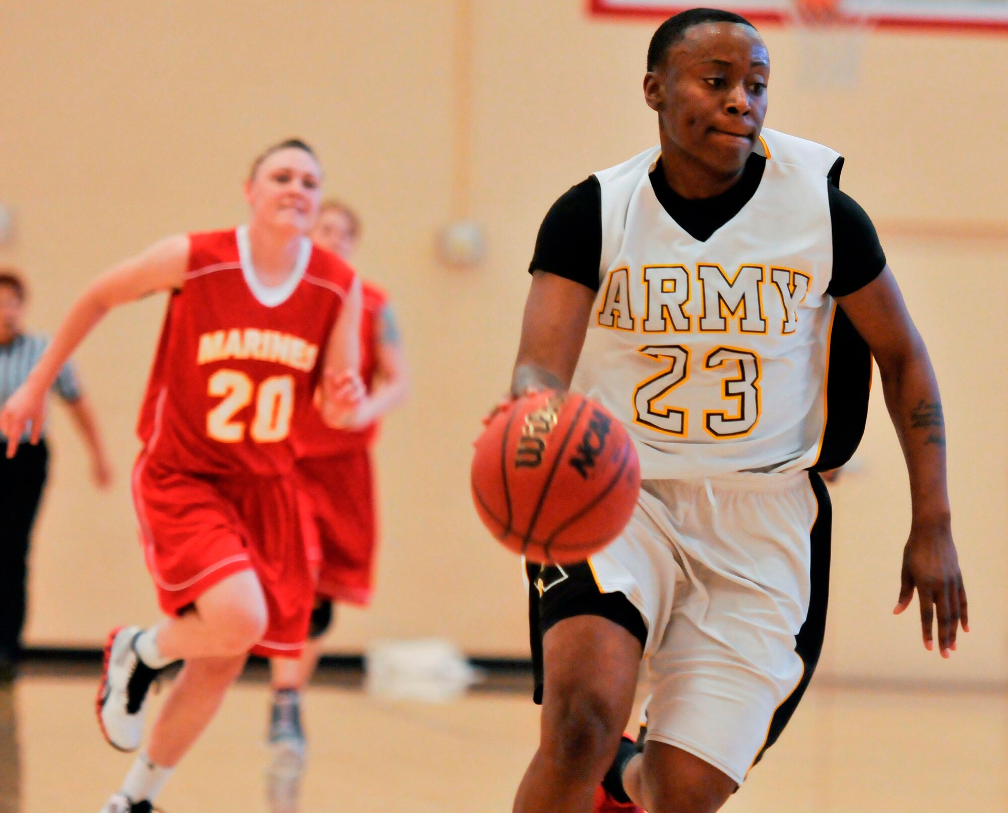 Army Sergeant Ebony Jackson, Fort Hood, Texas, has control of the ball with Marine Corporal Ashley Dunn, IIIMEFG-2, Okinawa, Japan, on her tail. During the third day of the Women’s Armed Forces Basketball Championship, the Marines and the Army faced-off. The Army was the ultimate victors with a score of 81. The Marine’s final points totaled 70.(U.S Air Force photo by Chris Cokeing)