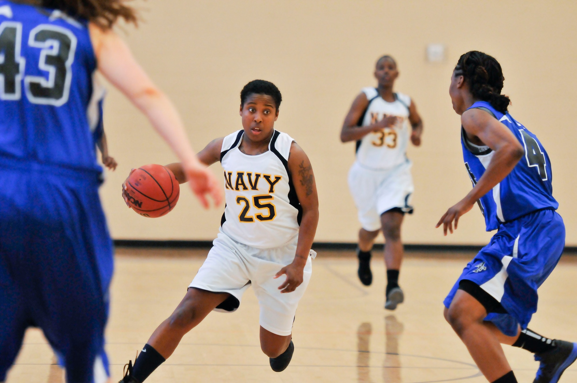 Navy Airman Brittany White, VFA 195 Atsugi, Japan, dribbles the ball while Captain Monica Mason, Ramstein Air Force Base, Germany, guards her. During the third day of the Women’s Armed Forces Basketball Championship the Air Force and the Navy went head to head. At half time the Air Force was up but during the second half they slowly lost their lead. By the end, the victor was clear as the Navy finished with 83 and the Air Force tailed behind with 73. (U.S Air Force photo by Chris Cokeing)