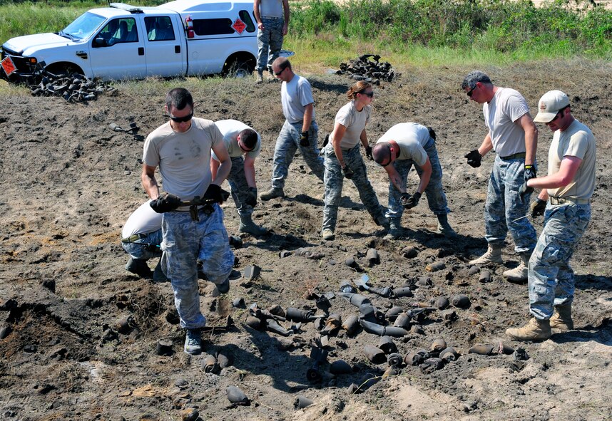 Members of the 20th Civil Engineer Squadron explosive ordnance disposal flight clean up the location after a recent detonation at Poinsett Range near Wedgefield, S.C., Sept. 23, 2010. EOD techs are called upon when unexploded bombs need to be dealt with.(U.S. Air Force photo by Senior Airman Daniel Phelps/Released)