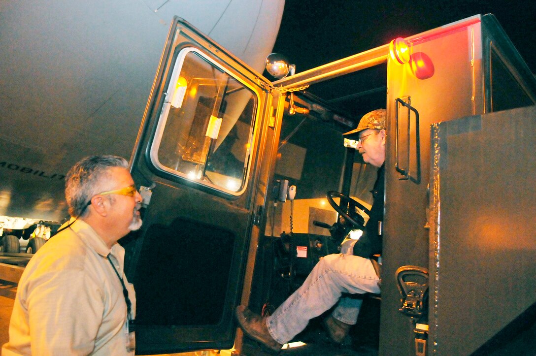 Mark Vasquez, C-5 Production team lead, talks with David Kitchens, driver of the tow vehicle that will move the C-5 out of the hangar and to a spot on the flightline. (U. S. Air Force photo by Sue Sapp)