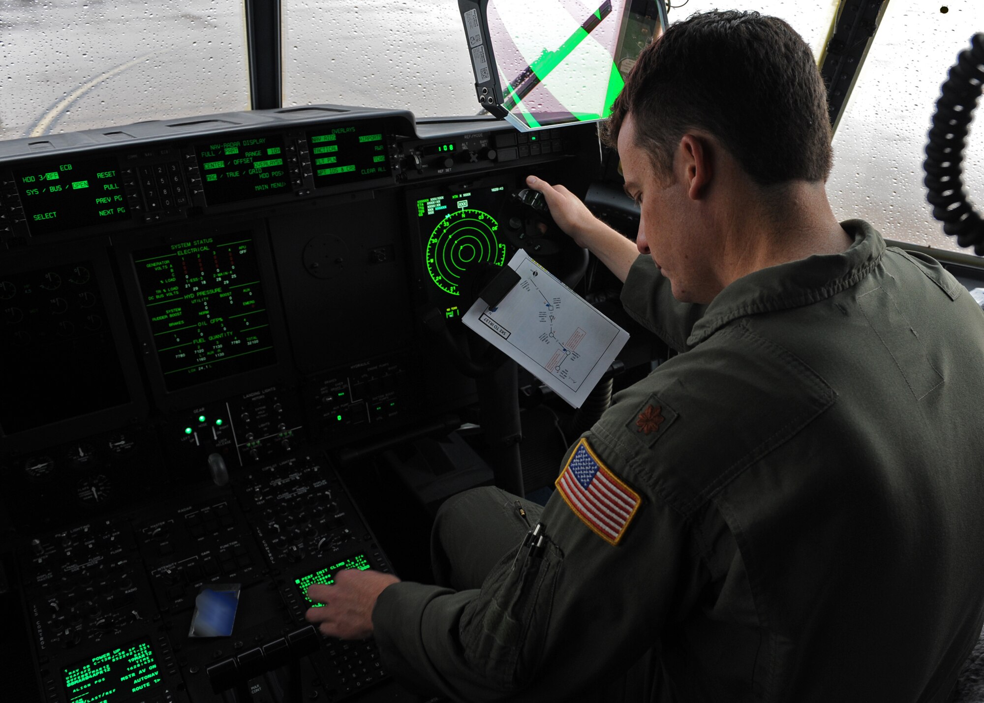 U.S. Air Force Maj. Justin Diehl, 317th Airlift Group chief executive officer, inputs flight information as part of C-130J training before take-off March 19, 2012 at Dyess Air Force Base, Texas. In the past, the training in the United States for C-130s didn’t match the routings and airdrop profiles that were being flown in Afghanistan or Iraq. Now, here at Dyess, training has been brought into the 21st century mirroring actual deployment tactics the pilots will face down range. This training supports current conflicts, but also helps 317th aircrews prepare to bring relief to nations in distress, such as Japan in 2011 and Haiti in 2010. (U.S. Air Force photo by Airman 1st Class Peter Thompson/Released)