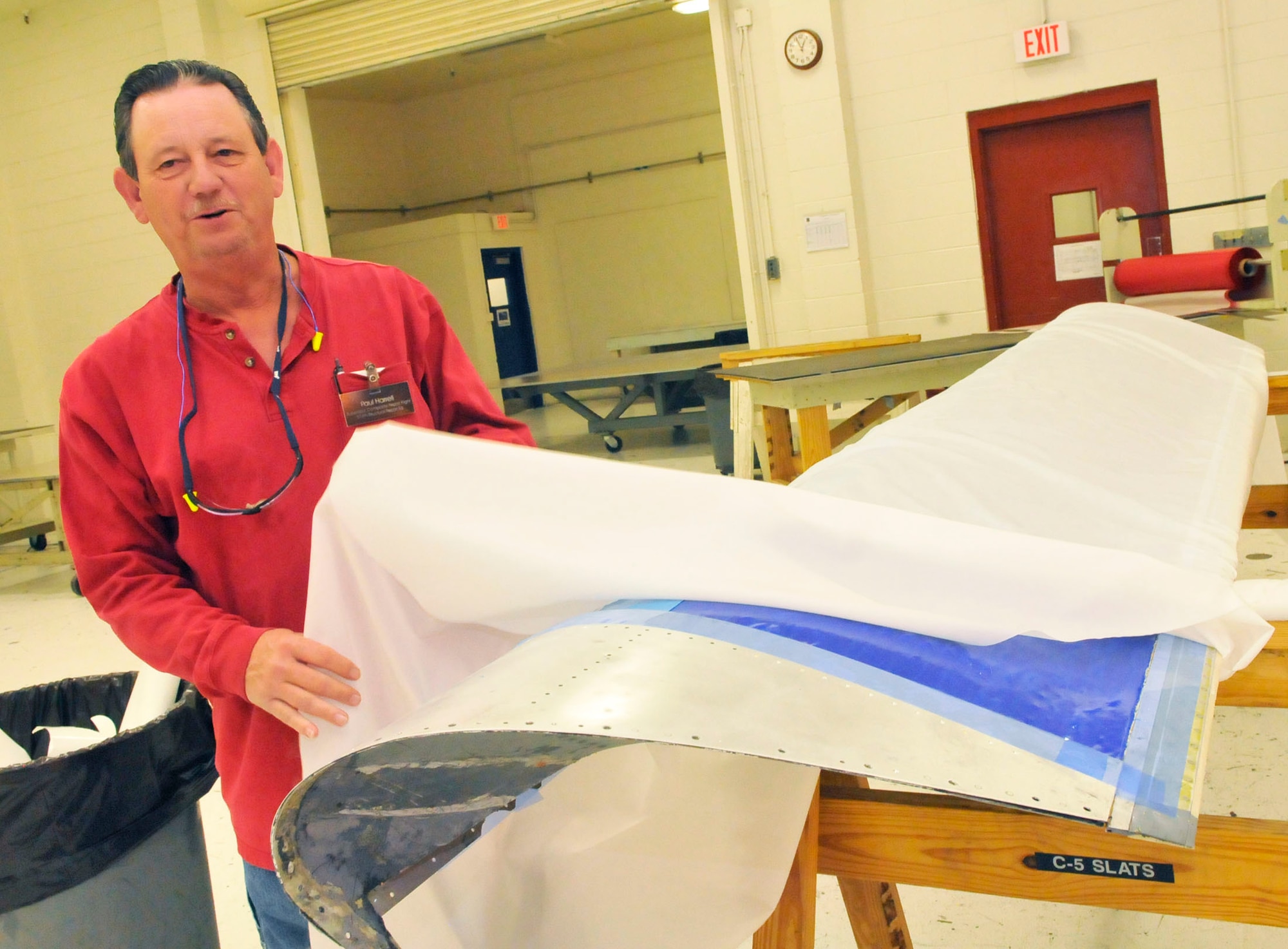 Paul Harrell, 574th structural repair Squadron composite repair flight supervisor, talks about the work done on aircraft parts before they are placed in the autoclave. (U. S. Air Force photo by Sue Sapp)