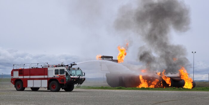 A Beale fire truck sprays down a simulated aircraft fire at Beale Air Force Base, Calif., March 19, 2012. Five trucks and 16 personnel were used to combat the simulated aircraft crash. (U.S. Air Force photo by Staff Sgt. Robert M. Trujillo/Released)