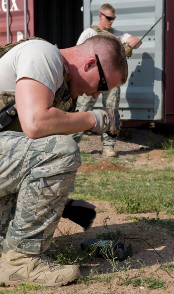 U.S. Air Force Senior Airman Todd Wycoff, 7th Civil Engineer Squadron, ensures the detonation trigger works properly prior to the detonation of M10A3 grenades March 26, 2012, at the Midland Police Department firing range in Midland, Texas. Military ordnances are detonated by Dyess explosive ordnance disposal teams due to their training and expertise. (U.S. Air Force photo by Airman 1st Class Jonathan Stefanko/ Released)