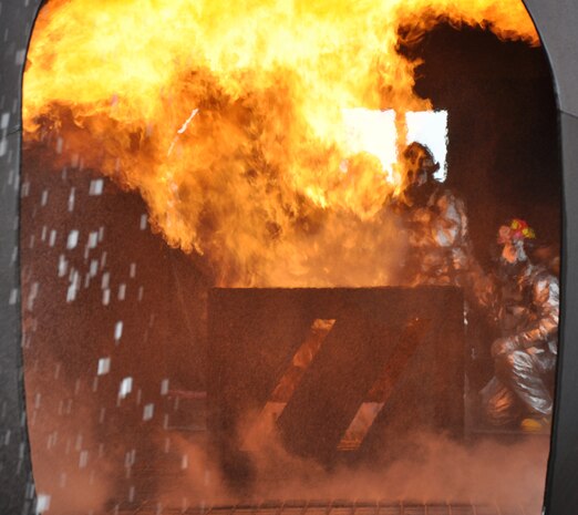 Beale firemen try to extinguish a cargo fire on a simulated aircraft at Beale Air Force Base, Calif., March 19, 2012. The fire department routinely uses the aircraft to show the many scenarios a firefighter can encounter in the field. (U.S. Air Force photo by Staff Sgt. Robert M. Trujillo/Released)