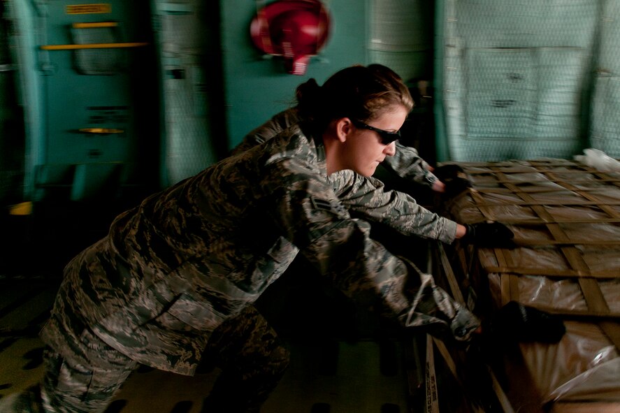 Airman 1st Class Lara Cook pushes a pallet into place on a C-5 aircraft at the 167th Airlift Wing, Shepherd Field, Martinsburg WV, on March 23 2012. Airmen assigned to the 2T2X1, air transportation career field, are responsible for passenger and cargo movement functions on a variety of aircraft types.  They must also know weight and balance factors, airlift transportation directives and documentation, cargo securing techniques, border clearance requirements, operation of materials handling and other types of loading equipment or devices and fleet service functions. (U.S. Air Force photo by Master Sgt Emily Beightol-Deyerle)