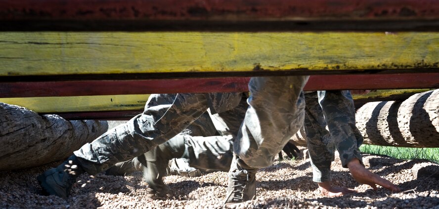 Airmen participate in one of 32 obstacle courses March 24, 2012, at the Warren Dodson training complex in Abilene, Texas. The course was hosted by the Airman Advisory Council to boost morale while supporting physical fitness. (U.S. Air Force photo by Airman 1st Class Jonathan Stefanko/ Released)