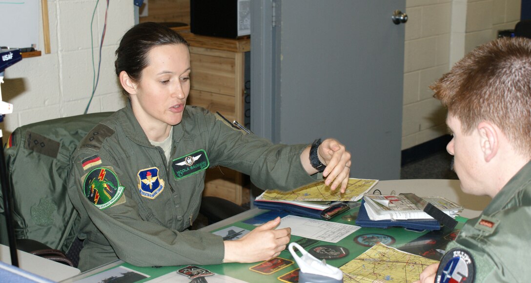 1Lt. Nicola Baumann, an instructor pilot with the 459th Flying Training Squadron, receives a pre-flight brief from a student Mar. 19, 2012 at Sheppard Air Force Base, Texas.  Baumann became just the second female fighter pilot in the history of the German Air Force back in 2007 after completing the Euro-Nato Joint Jet Pilot Training program at Sheppard.  (U.S, Air Force photo/Dan Hawkins)