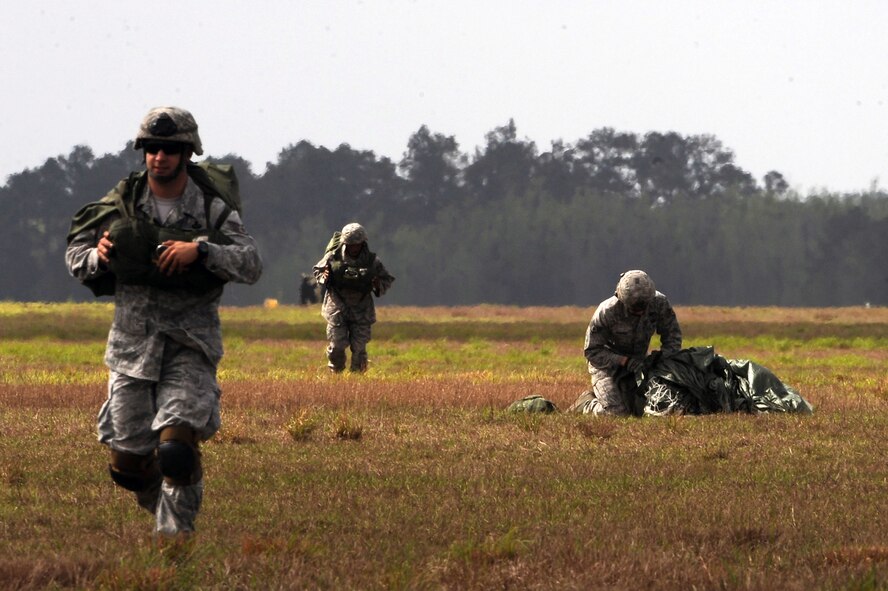 U.S. Air Force Airmen from the 820th Base Defense Group pack up their parachutes and clear a drop zone at Moody Air Force Base, Ga., March 21, 2012.  To become certified, Airmen must complete the U.S.  Army Basic Airborne Course at Fort Benning, Ga. (U.S. Air Force photo by Staff Sgt. Ciara Wymbs/Released)
