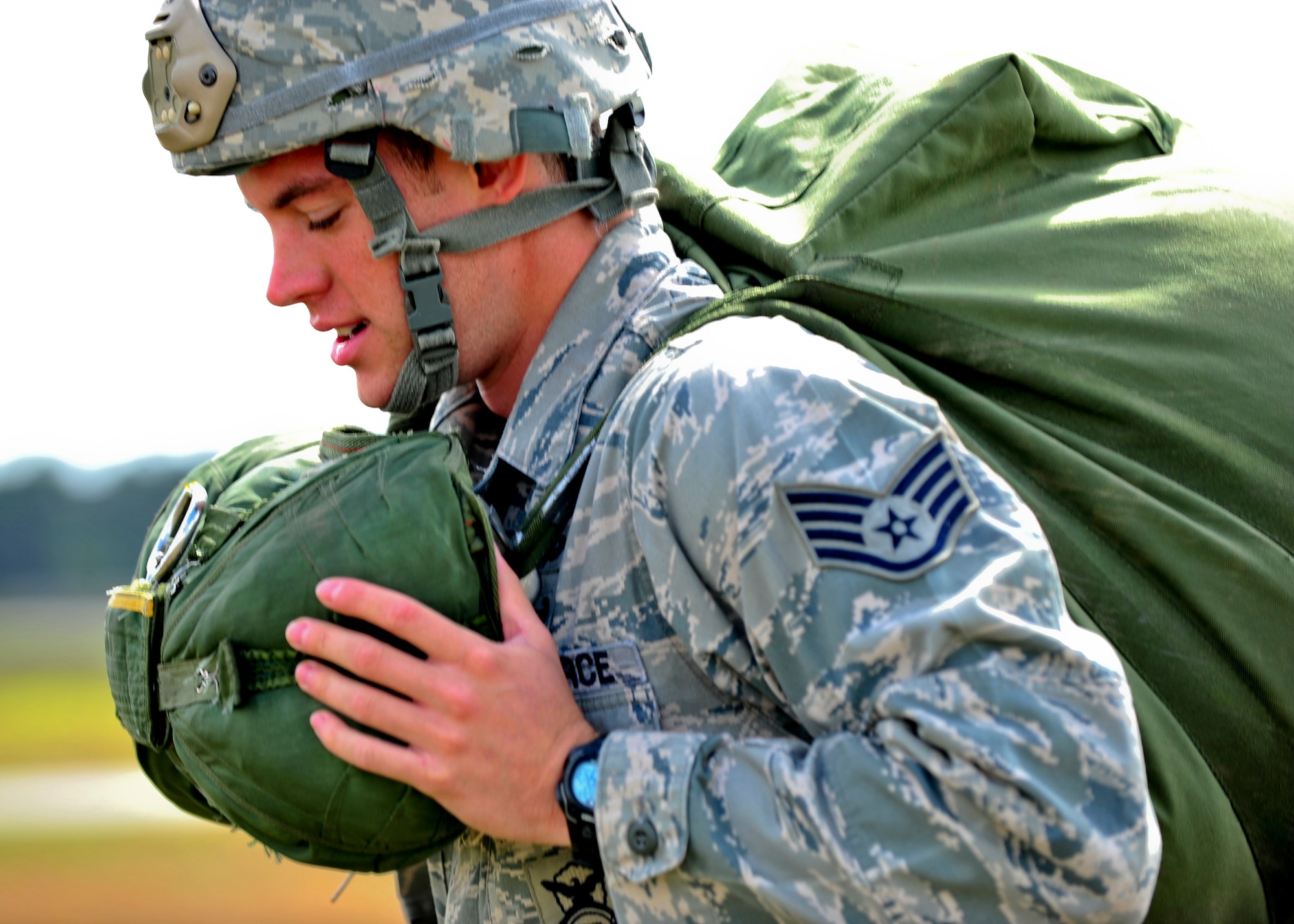 U.S. Air Force Staff Sgt. Jefferson Fraser, 823rd Base Defense Squadron, collects his parachute and heads back to the rally point at Moody Air Force Base, Ga., March 21, 2012. It takes an Airman approximately five minutes to gather his or her parachute after landing.(U.S. Air force photos by Staff Sgt. Stephanie Mancha/Released)
