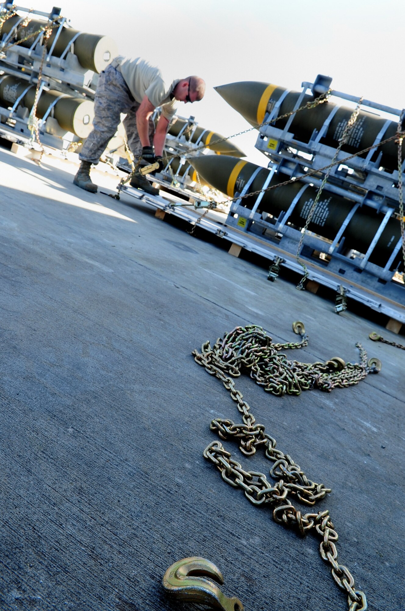 Tech. Sgt. James Pyeatt, 86th Munitions Squadron, secures a chain to a pallet during a tactical air munitions rapid response package exercise at Ramstein Air Base, Germany, March 27, 2012. Members of the 86th MUNS participate in a TARRP exercise quarterly to stay familiar with current processes and become more efficient for real world missions. (U.S. Air Force photo by Senior Airman Brittany Perry)