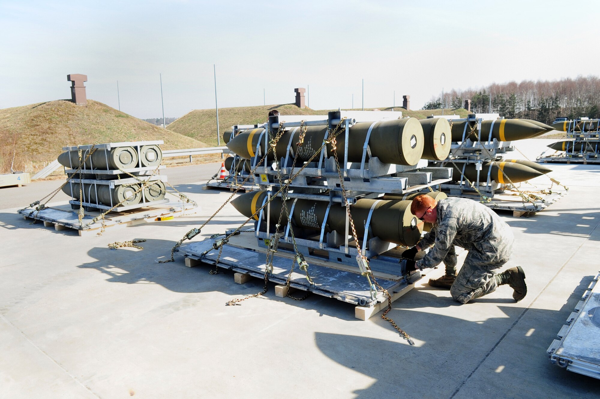 Airman 1st Class David Reed, 86th Munitions Squadron, secures a chain to a pallet during a tactical air munitions rapid response package exercise at Ramstein Air Base, Germany, March 27, 2012. Members of the 86th MUNS participate in a TARRP exercise quarterly to stay familiar with current processes and become more efficient for real world missions. (U.S. Air Force photo by Senior Airman Brittany Perry)