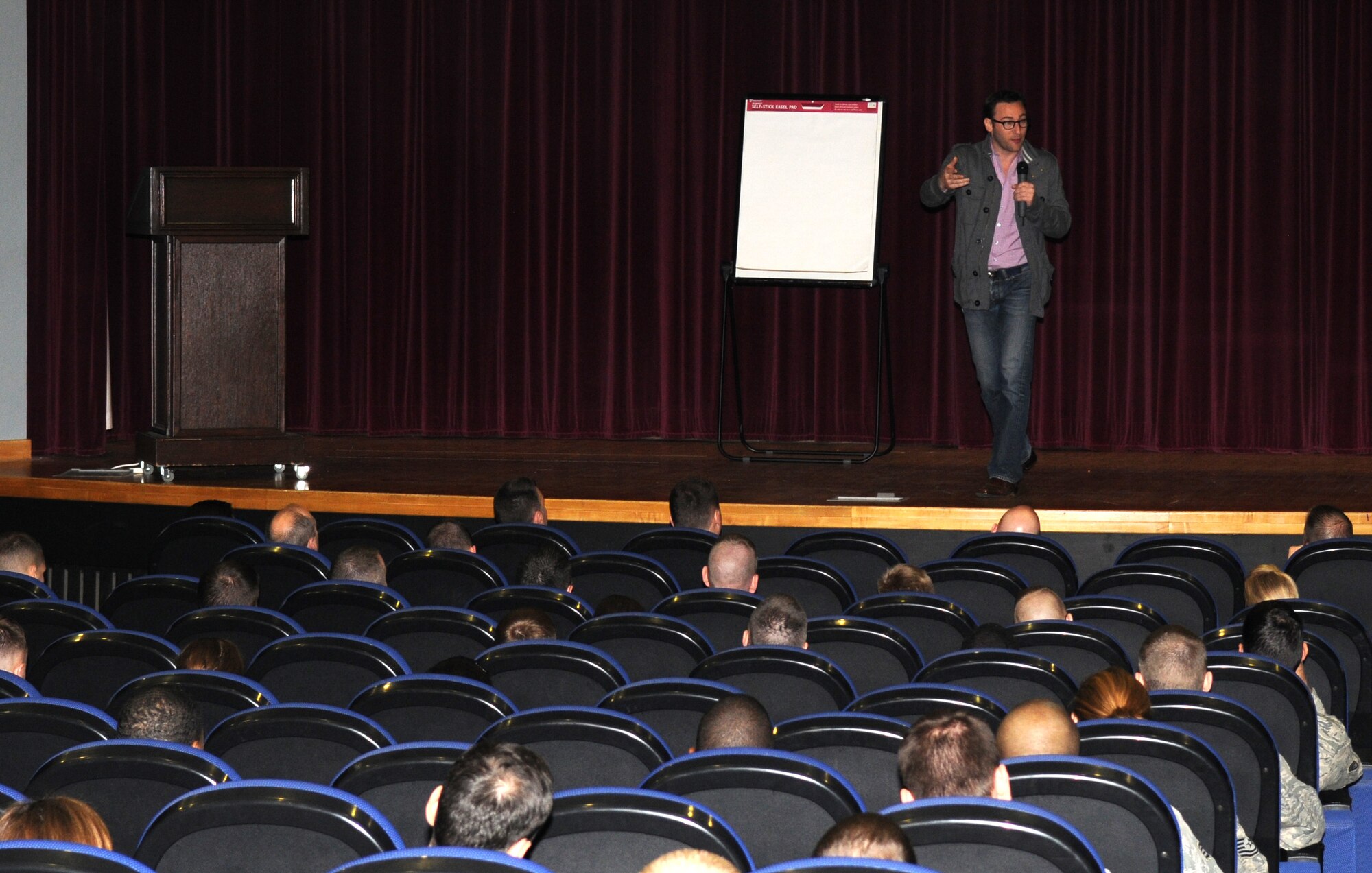 RAF MILDENHALL, England – Simon Sinek, a motivational speaker, speaks to Team Mildenhall Airmen during a lecture based off his book, “Start with Why,” March 27, 2012 at the base theater. Sinek was here as a guest lecturer in the 100th Air Refueling Wing Century Lecture series. The lecture series brings in guest speakers who are well rounded in the fields of leadership and mentoring to develop Airmen leadership skills. The series will continue throughout the year. (U.S. Air Force photo/Senior Airman Rachel Waller) 