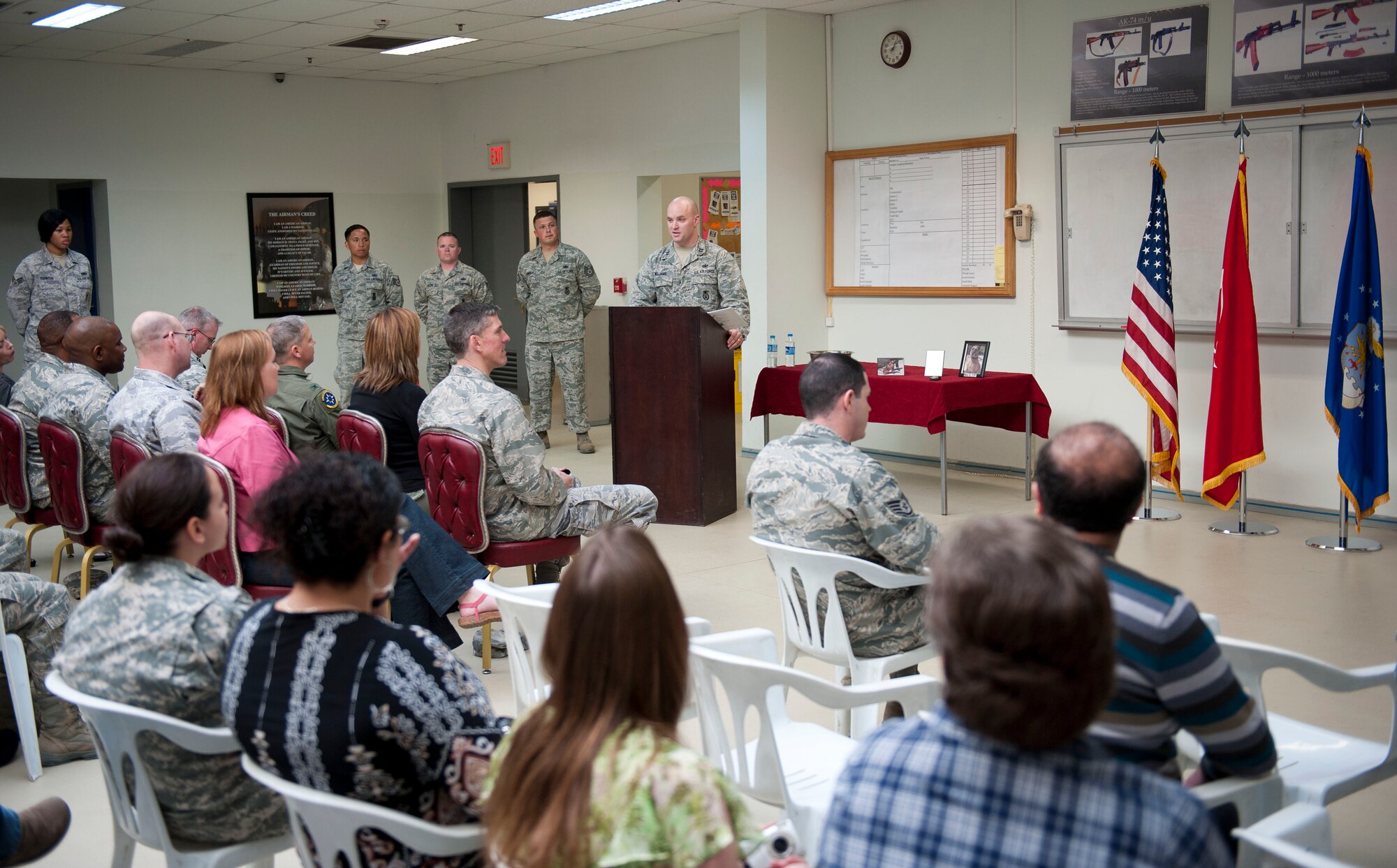 Capt. Jason Williams, 39th Security Forces Squadron operations officer, speaks during the retirement of military working dog Max March 23, 2012 in the 39th SFS guardmount room at Incirlik Air Base, Turkey. The process for a retiring military working dog adoption includes various steps from the dog and adopted owner’s location all the way to Lackland Air Force Base, Texas. At Lackland, each dog’s records and an aggressiveness film compiled by the dog’s handler are evaluated to determine each dog’s adoption suitability. (U.S. Air Force photo by Senior Airman William A. O'Brien/Released)