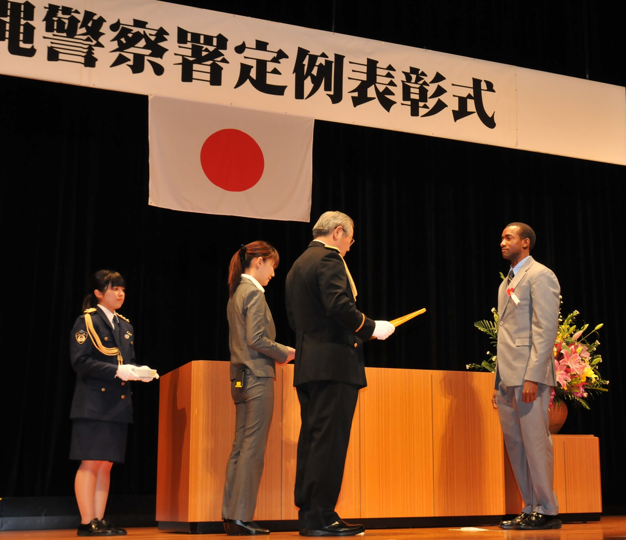 Special Agent Keith Hayden (right), U.S. Air Force Office of Special Investigations Detachment 624, receives a letter of appreciation from Kiyomasa Yasumura (center), Chief of the Okinawa Police Station, at the Okinawa Police Station's annual appreciation ceremony in Okinawa City, Japan, February 22, 2012. Hayden received letter of appreciation for ground breaking joint investigative efforts in fraud cases during 2011. (U.S. Air Force courtesy photo/Released)