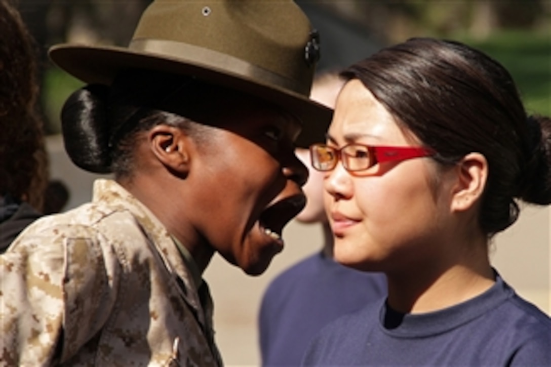 Drill instructor Sgt. Marline Dominic (left) explains to Rachel Murray the importance of sounding off during a pool function at the Minnesota Twin Cities Recruiting Station on March 24, 2010.  Murray, a member of the Recruiting Station Delayed Entry Program, will ship off to boot camp later this year.  