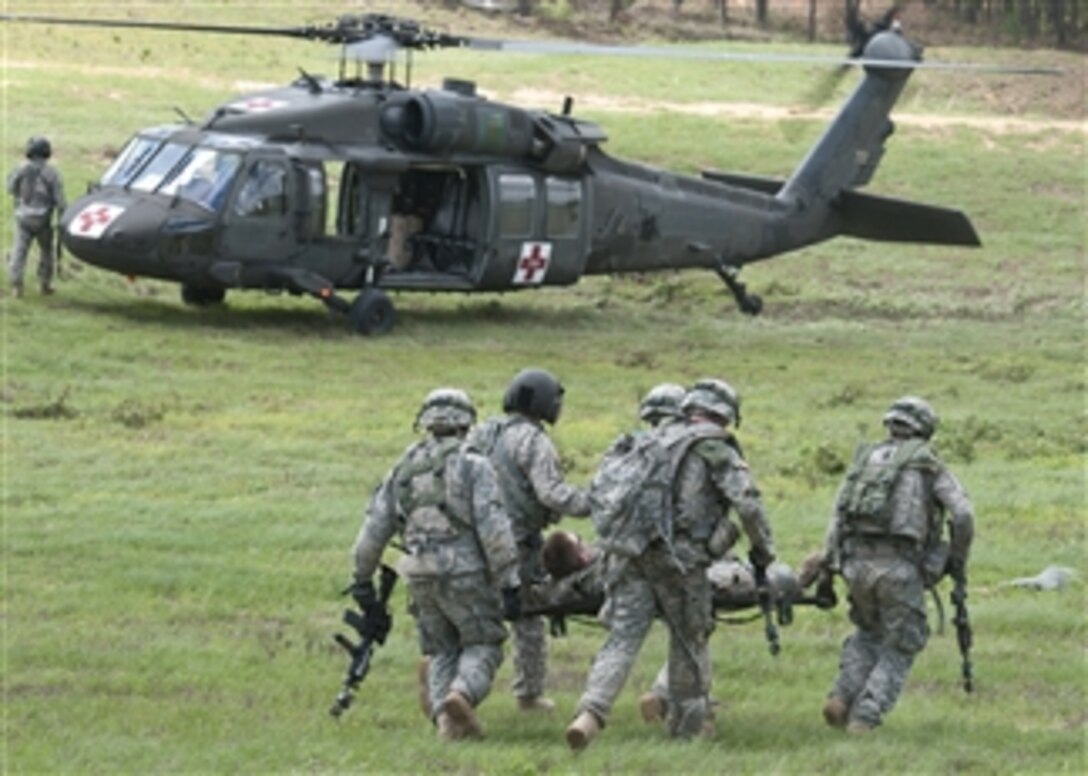 U.S. Army soldiers with Bravo Company, 2nd Battalion, 14th Infantry Regiment, 10th Mountain Division rush a simulated casualty towards a medical evacuation helicopter outside the mock village of Turani during a training exercise at the Joint Readiness Training Center, Fort Polk, La., on March 19, 2012.  