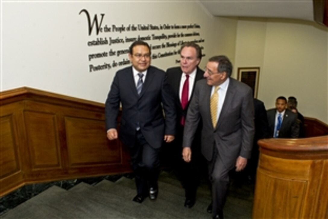 U.S. Defense Secretary Leon E. Panetta escorts Peruvian Defense Minister Luis Alberto Otarola Penaranda, left, and Peruvian Ambassador Harold W. Forsyth, right, through the Pentagon, March 28, 2012.  The leaders are meeting to discuss bilateral defense issues. 