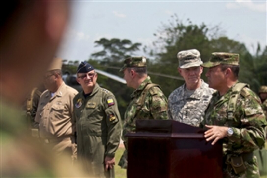 U.S. Army Gen. Martin E. Dempsey, chairman of the Joint Chiefs of Staff, listens as Colombian Gen. Alejandro Navas, commander of Colombia's armed forces, speaks on Joint Task Force-Vulcano near Tibu, Colombia, March 27, 2012. Dempsey visited Colombian troops and engineers, and the U.S. troops who helped train them.