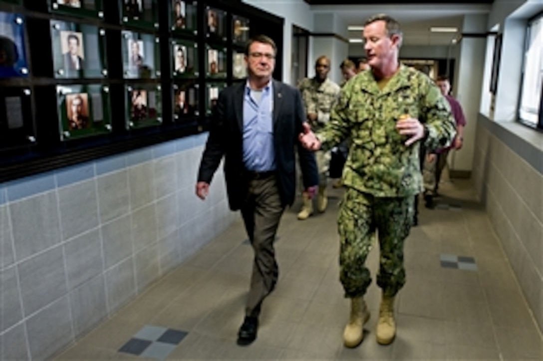 Navy Adm. William H. McCraven, commander of U.S. Special Operations Command, escorts Deputy Defense Secretary Ashton B. Carter through the corridors of SOCOM headquarters on McDill Air Force Base, Fla., March 28, 2012.