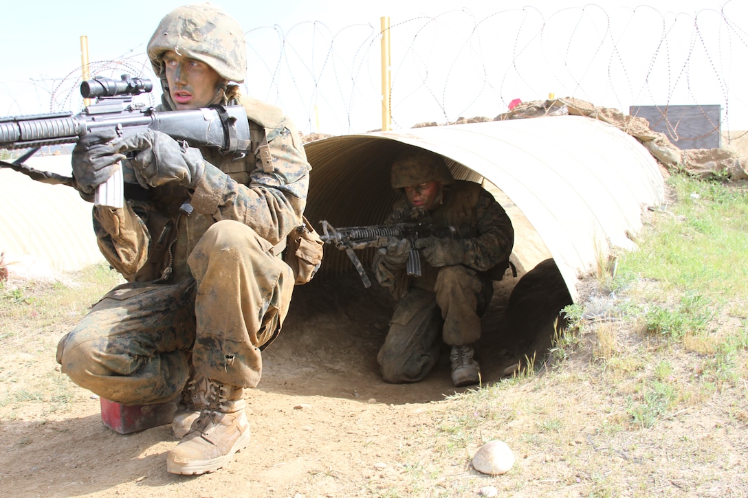 Recruit William Trump and Recruit Nicholas Sizemore, Company K, 3rd Recruit Training Battalion, move through tunnels and various other obstacles to complete Copeland's Assault at the Crucible aboard Edson Range, Camp Pendleton, Calif., March 28. Copeland's Assault is a simulated combat exercise where each fire team must carry an ammunition can to a resupply point.
