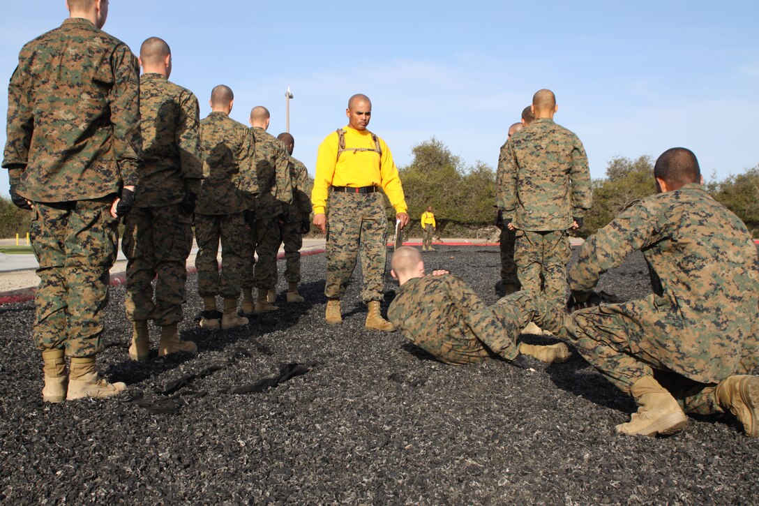 Company F recruits demonstrate a proper left fall March 28 while testing out for their tan belt aboard Marine Corps Recruit Depot San Diego. To graduate recruit training all recruits must achieve their tan belt, to do so they must be able to demonstrate any tan belt move if asked.