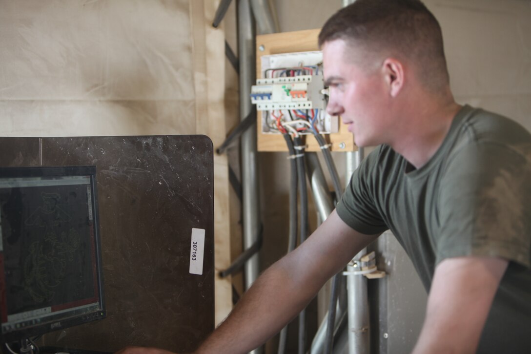 Lance Cpl. Steven Warren, a machinist with Maintenance Company, Marine Air-Ground Task Force Support Battalion 11.2, 1st Marine Logistics Group (Forward), demonstrates how a computer creates a series of straight cuts that are used to carve designs into metal at Camp Leatherneck, Afghanistan, March 29.